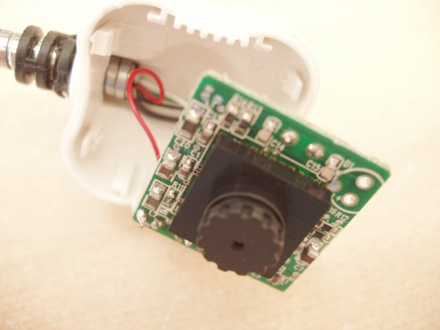 Picture showing interior of the webcam. The front of a small PCB has some surface mount components and the actual camera mounted on it.